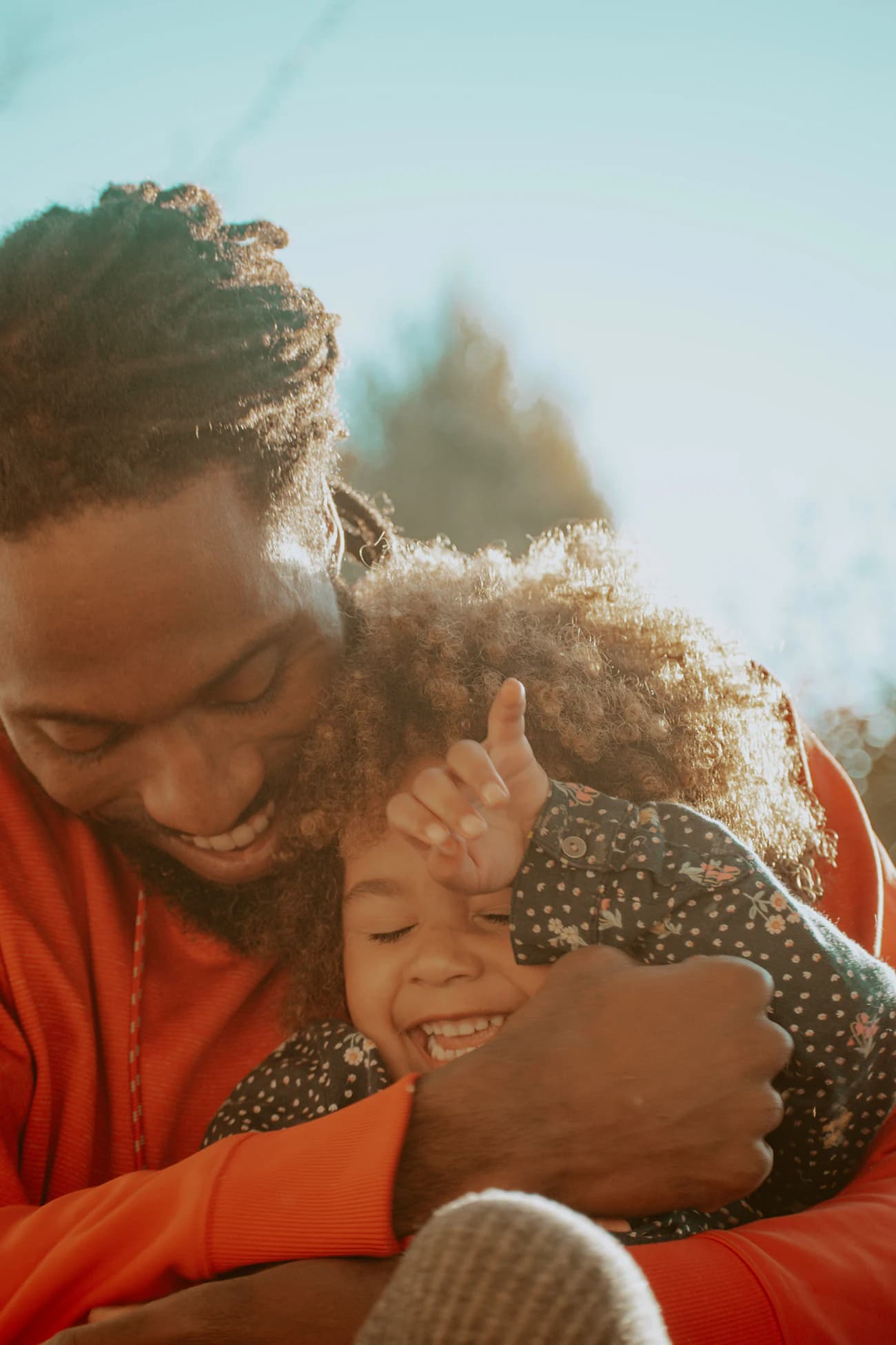 A father holding his young daughter